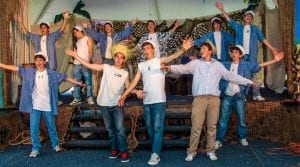 Boys wearing straw hats and blue jeans in theater performance