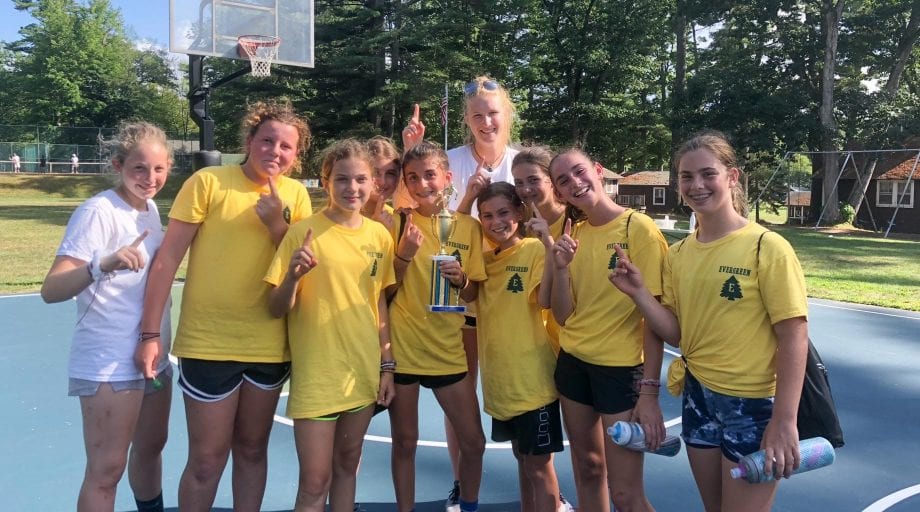 Girls in yellow holding trophy