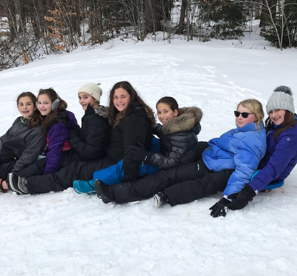 Campers sledding during a camp reunion