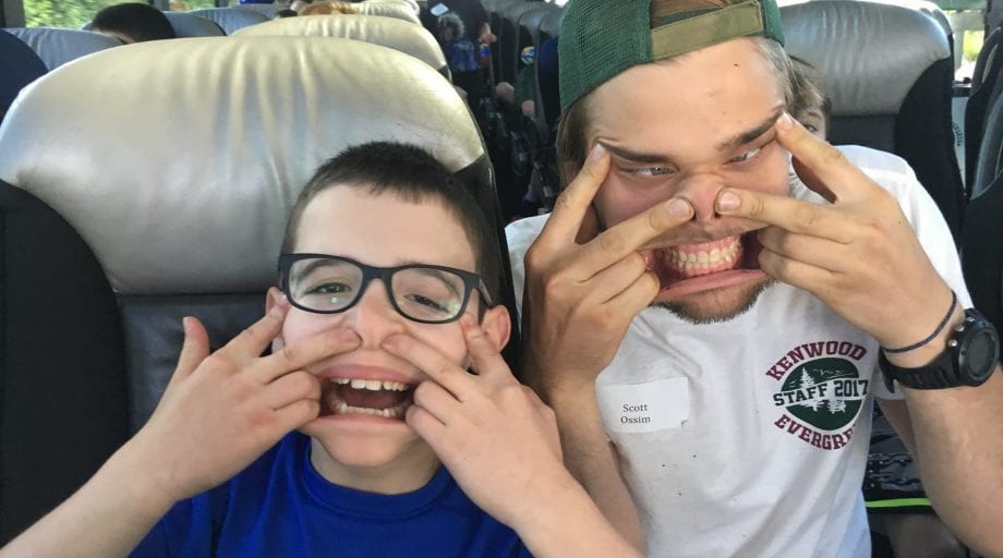 Campers making silly faces on the bus