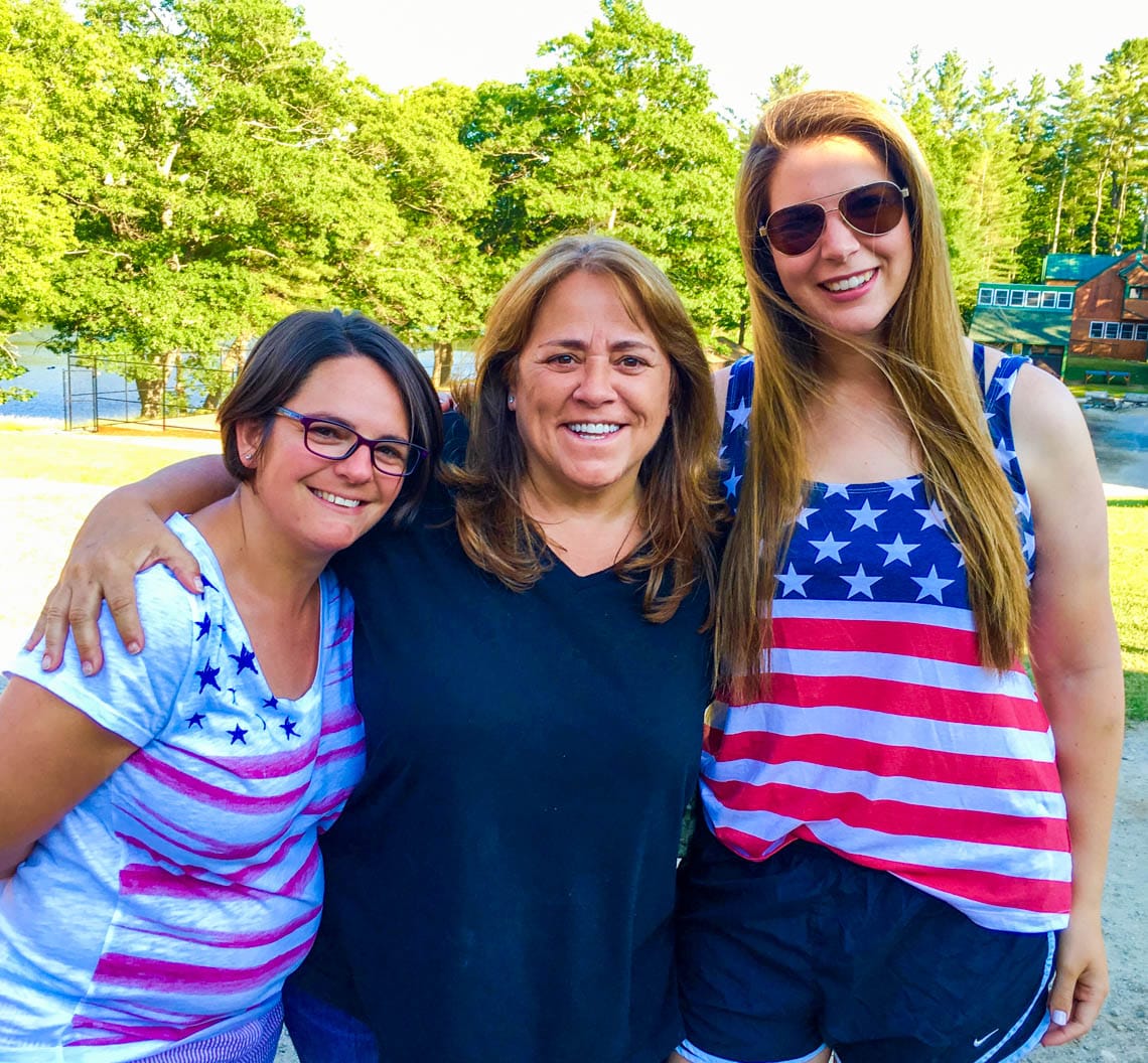 Three female camp staff smiling