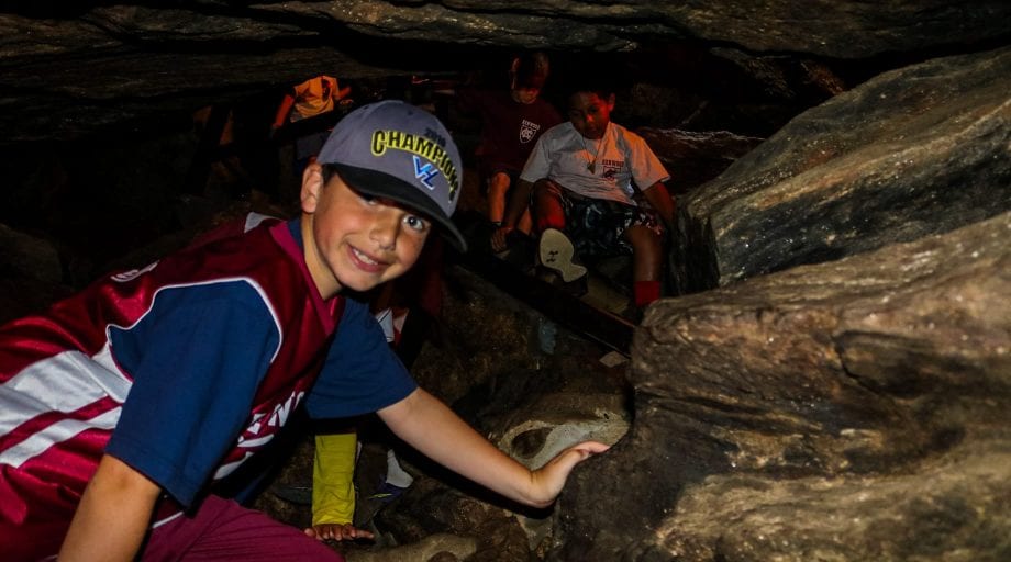 Boys exploring dark caves