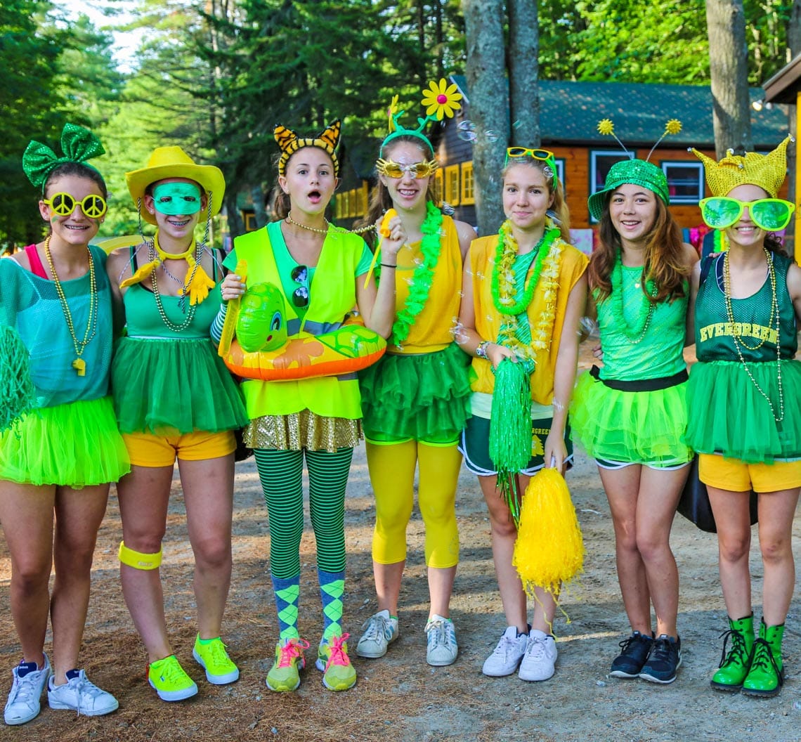 Green team dressed up for color war smiling