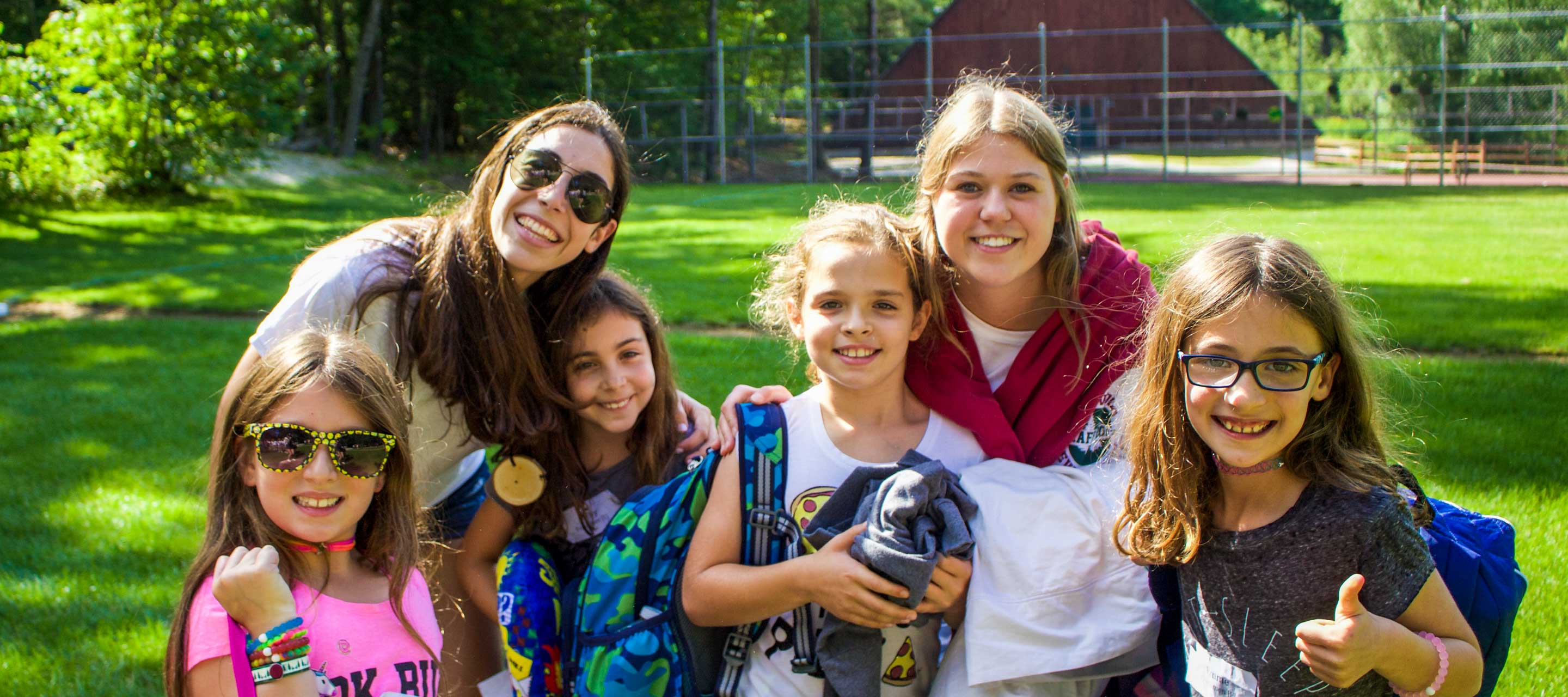 Group of female campers and staff outside smiling