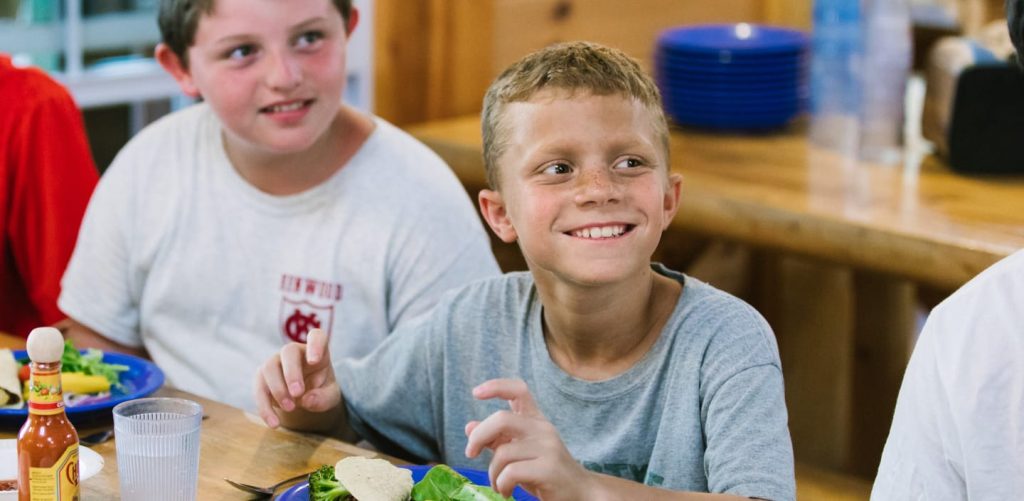 Boys eating lunch in dining hall