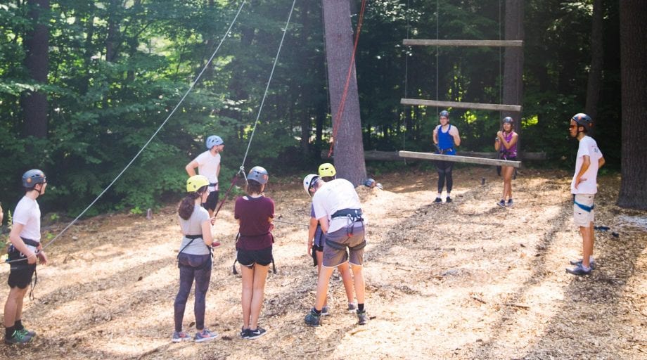 Campers on high ropes course belaying