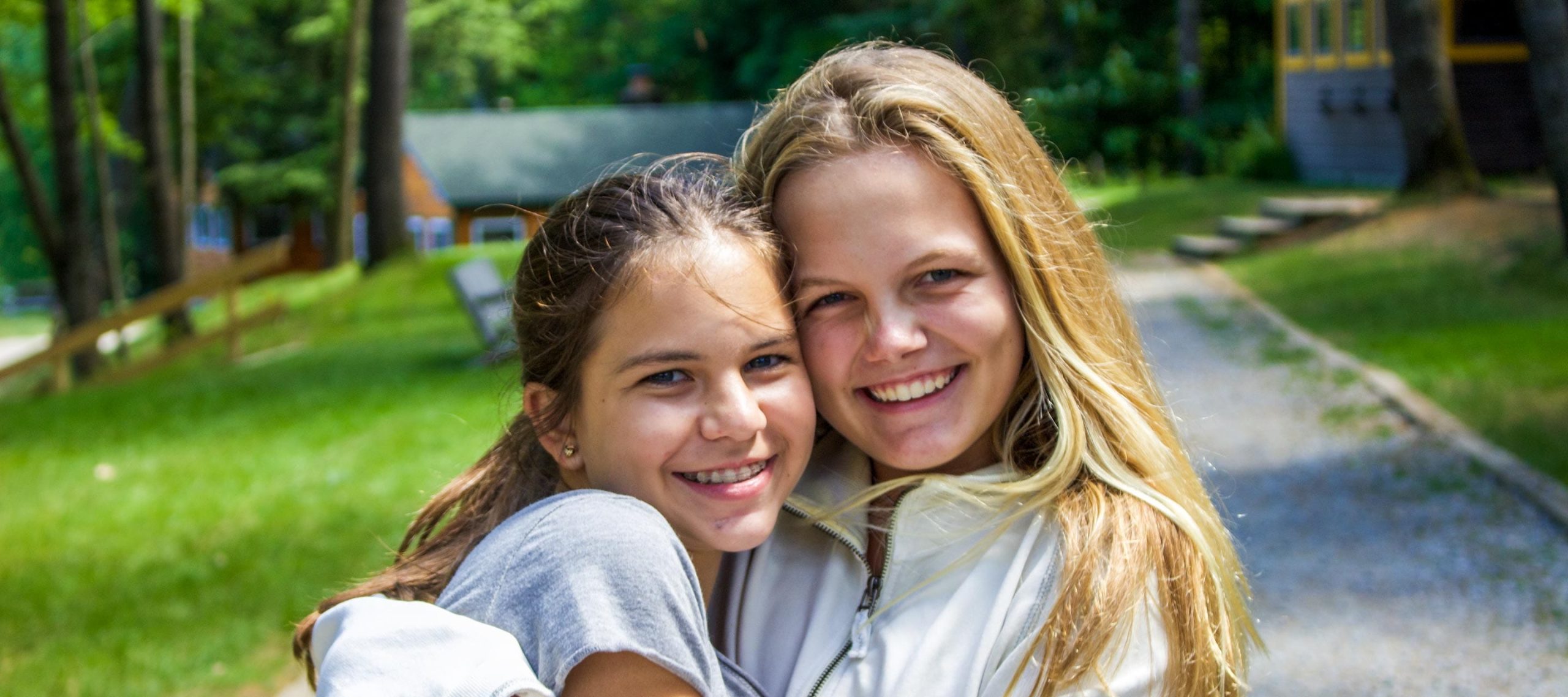 Two female campers smiling outside