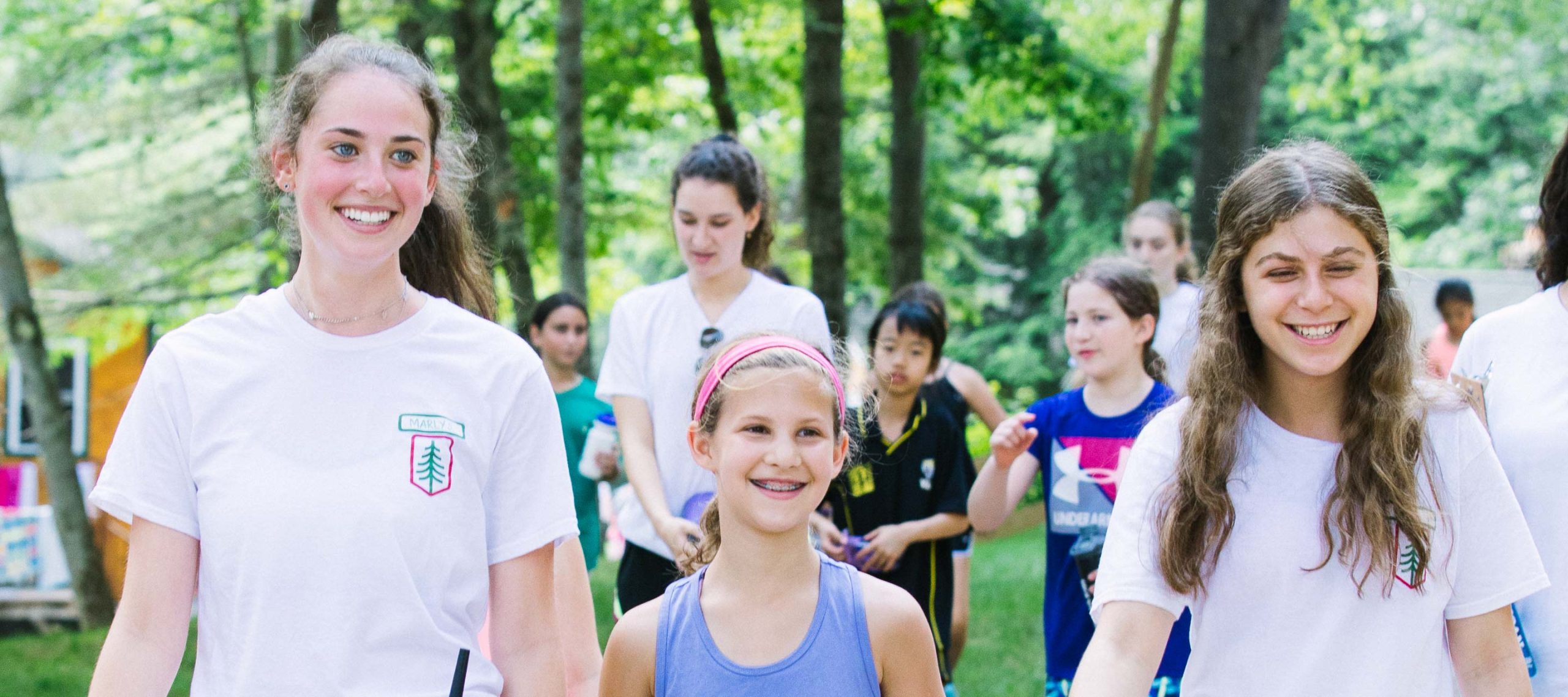 Staff and camper walking together