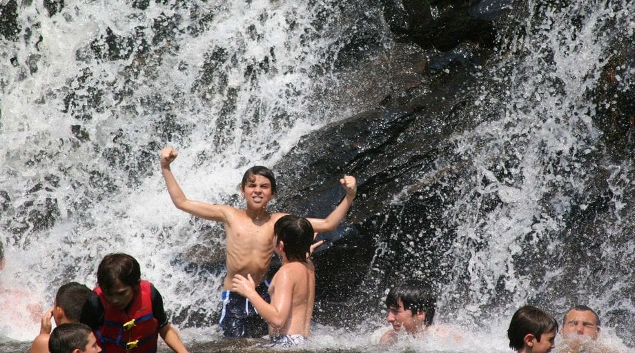 Boy by waterfall