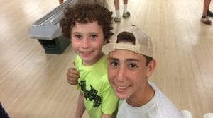 Big brothers smiling at a bowling alley