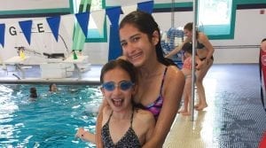 Big sisters by indoor swimming pool