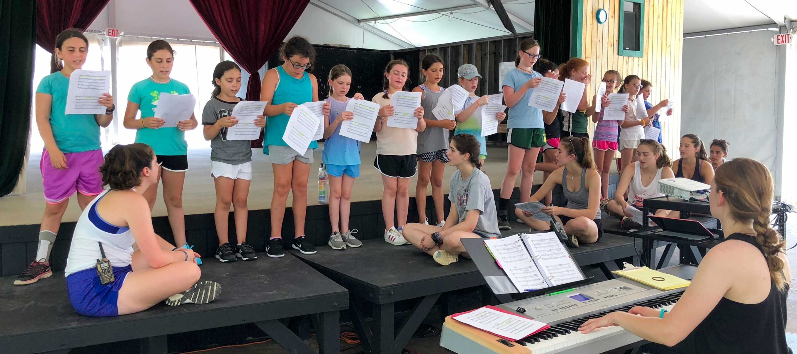 Girls singing in theater on stage