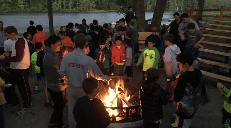 Campers attending a campfire during Rookie Day